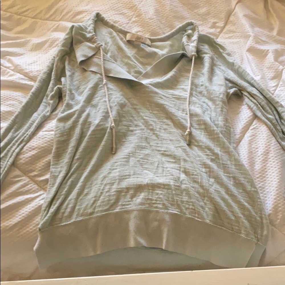 Medium green long- sleeved shirt.